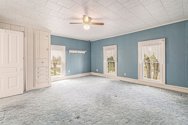 310 E Unadilla St, Pinckney, MI 48169 - unfurnished bedroom with carpet, multiple windows, ornamental molding, and ceiling fan