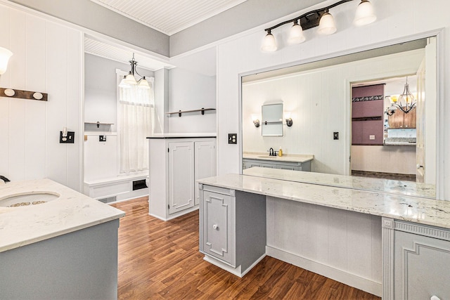 310 E Unadilla St, Pinckney, MI 48169 - full bath with a sink, visible vents, wood finished floors, and two vanities