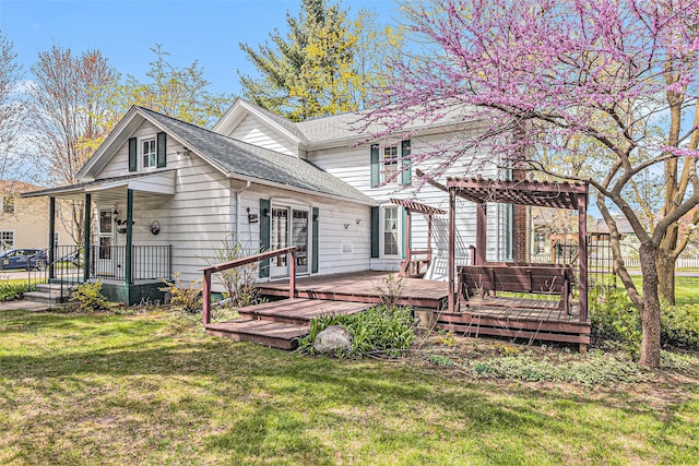 310 E Unadilla St, Pinckney, MI 48169 - back of house featuring a lawn, a pergola, a shingled roof, and a deck