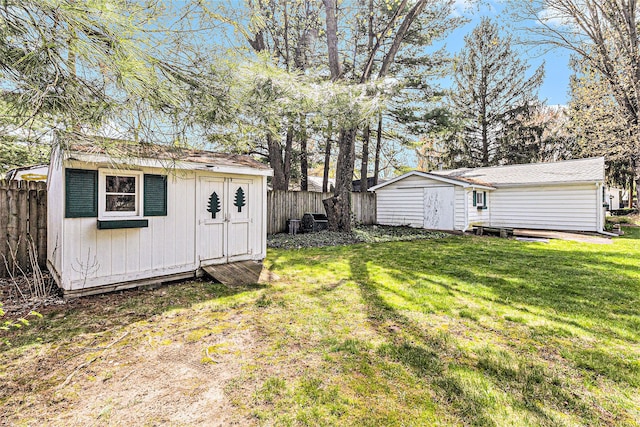 310 E Unadilla St, Pinckney, MI 48169 - view of yard with an outbuilding, a fenced backyard, and a storage unit