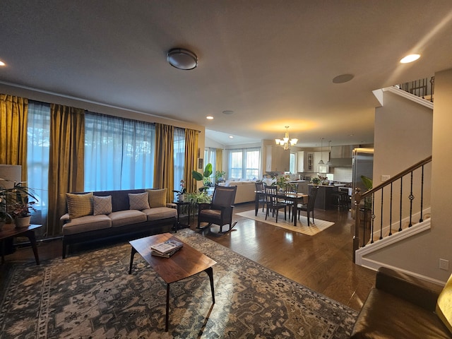 living area featuring recessed lighting, stairs, wood finished floors, and a chandelier