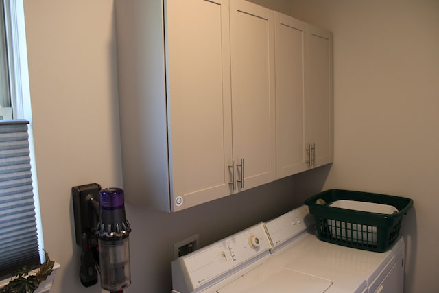 laundry room with cabinet space and separate washer and dryer