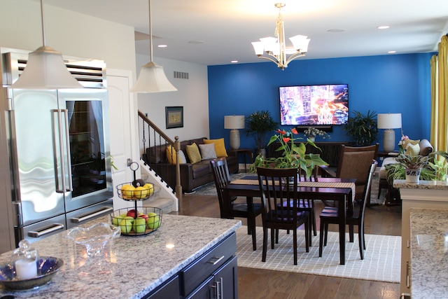 dining room featuring visible vents, an inviting chandelier, stairs, dark wood-style flooring, and recessed lighting
