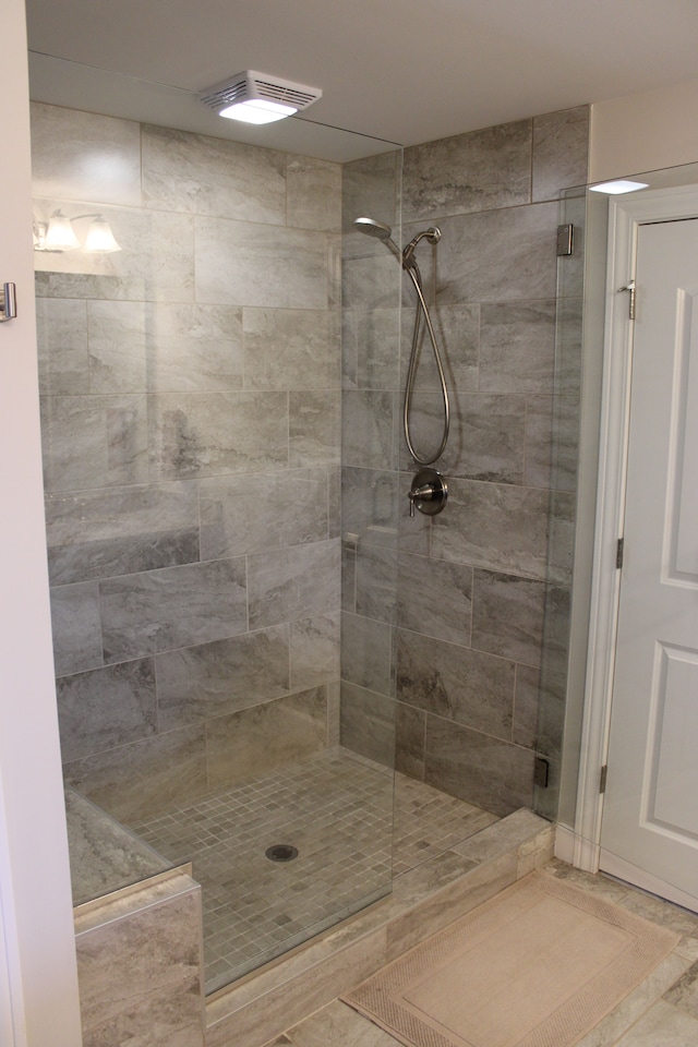 bathroom with visible vents and a stall shower