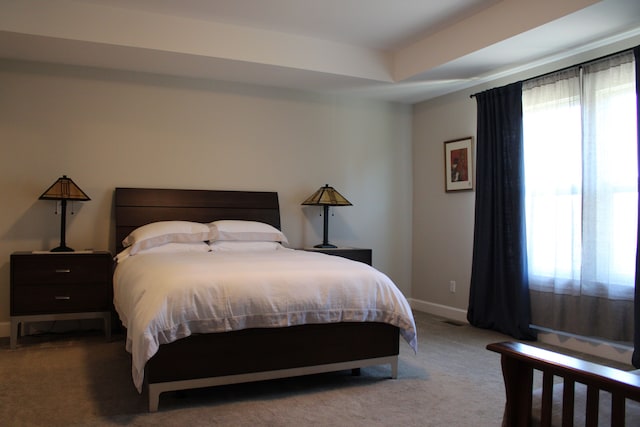 carpeted bedroom featuring baseboards