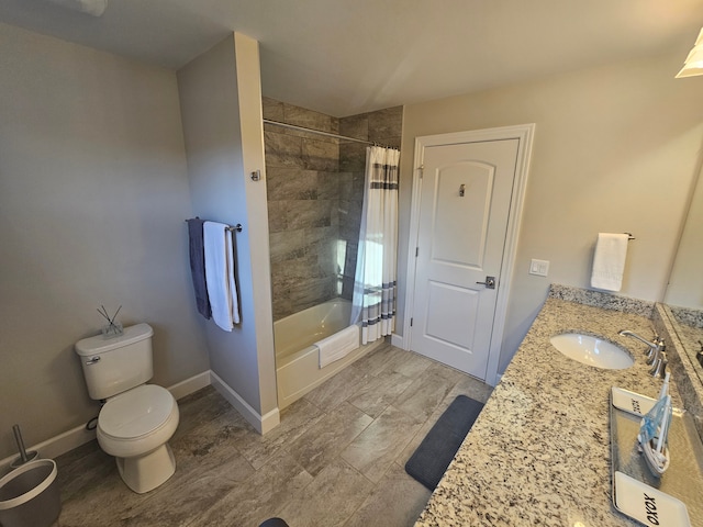 full bath featuring a sink, double vanity, toilet, baseboards, and shower / tub combo