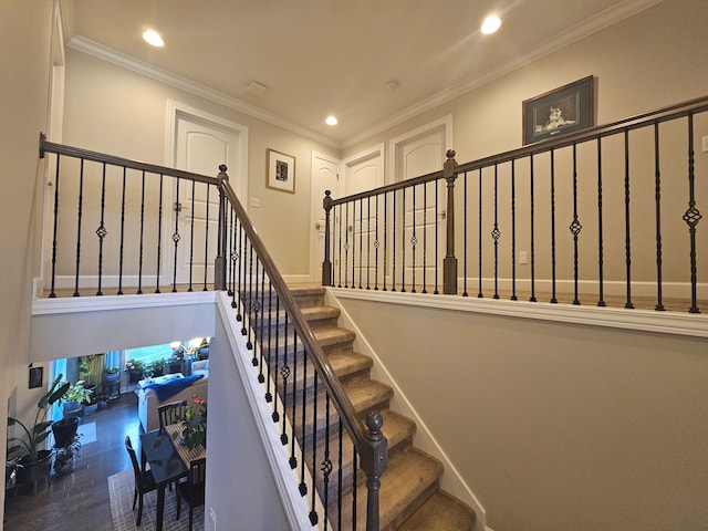 stairway with recessed lighting and ornamental molding