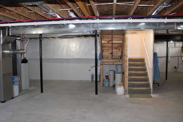 unfinished basement with stairway, heating unit, and gas water heater