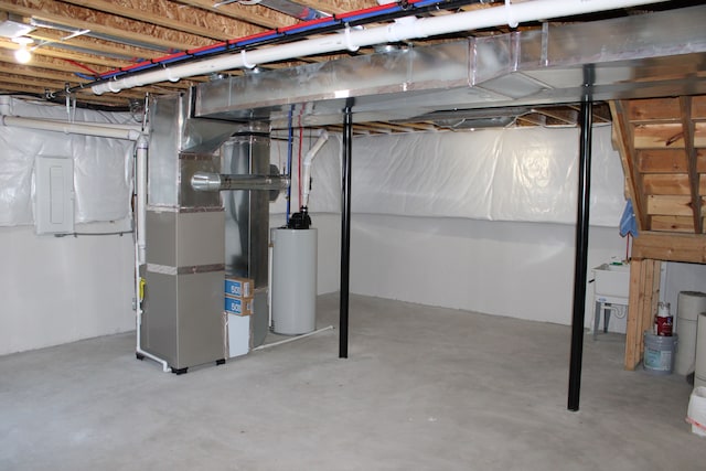 unfinished below grade area featuring heating unit, water heater, and electric panel