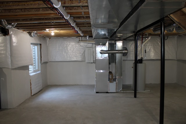 below grade area featuring heating unit, water heater, and electric panel