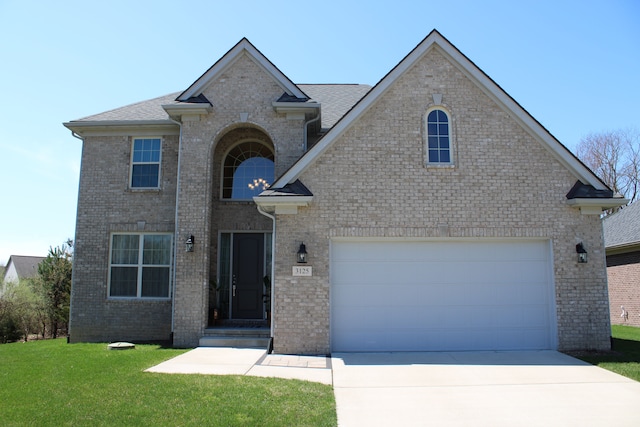 traditional-style house featuring brick siding, driveway, and a front lawn
