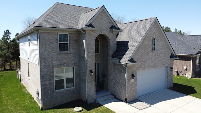 traditional home with brick siding, a front lawn, and concrete driveway