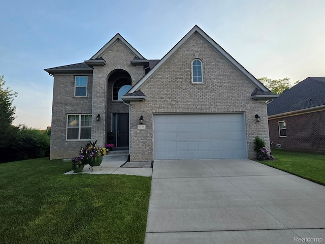 3125 Fortune Ln, Commerce Twp, MI 48390 - traditional-style home featuring a front yard, driveway, and brick siding