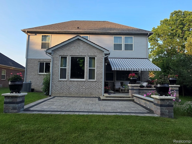 3125 Fortune Ln, Commerce Twp, MI 48390 - rear view of property featuring a lawn, a patio, and brick siding