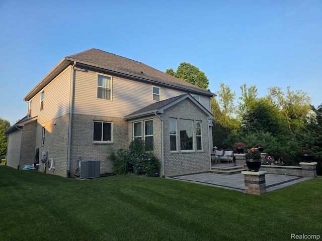 3125 Fortune Ln, Commerce Twp, MI 48390 - rear view of house with a patio, a lawn, and brick siding