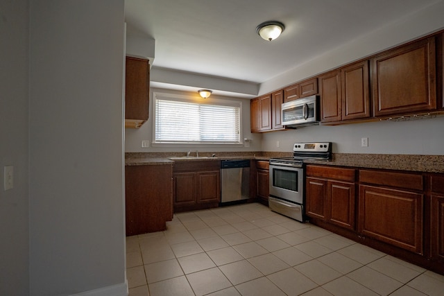 31825 Eveningside, Fraser, MI 48026 - kitchen featuring appliances with stainless steel finishes, a sink, light tile patterned flooring, and brown cabinets
