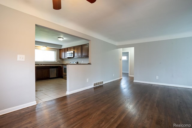 31825 Eveningside, Fraser, MI 48026 - unfurnished living room featuring a ceiling fan, wood finished floors, baseboards, and a sink