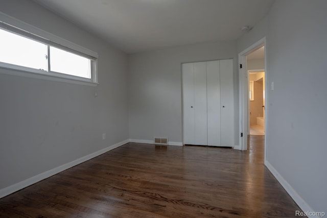 31825 Eveningside, Fraser, MI 48026 - unfurnished bedroom with dark wood-style floors, baseboards, and a closet