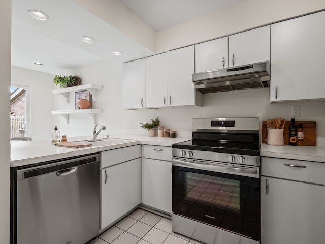 kitchen featuring a sink, light countertops, under cabinet range hood, stainless steel appliances, and white cabinetry