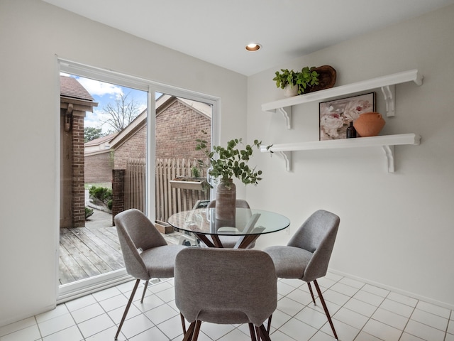 dining space with light tile patterned floors and recessed lighting