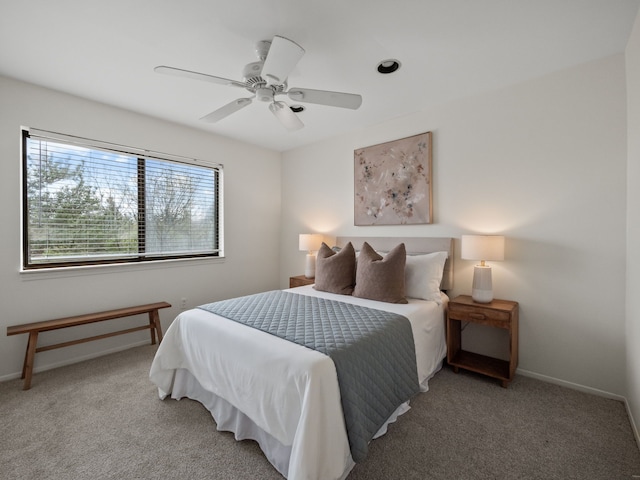 bedroom with a ceiling fan, baseboards, and carpet