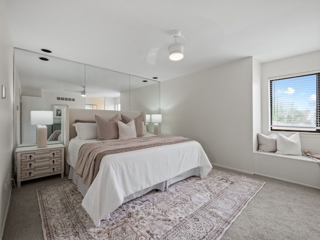 bedroom featuring carpet floors, baseboards, a ceiling fan, and visible vents