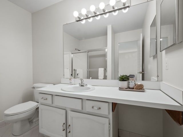 bathroom featuring vanity, toilet, and a stall shower