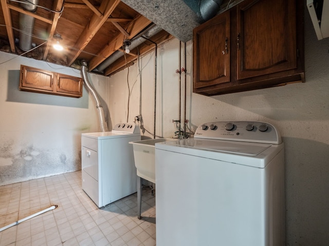 washroom featuring washer and dryer and cabinet space