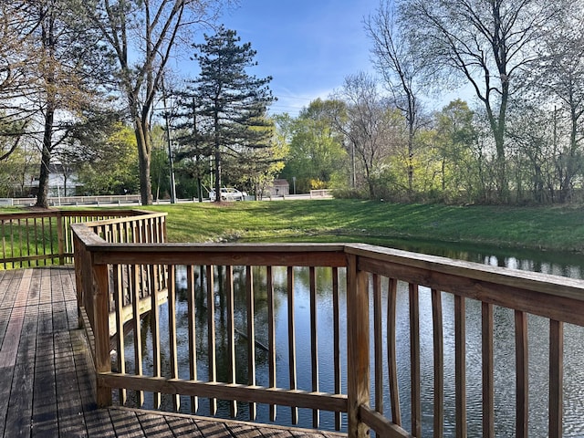 wooden deck featuring a lawn