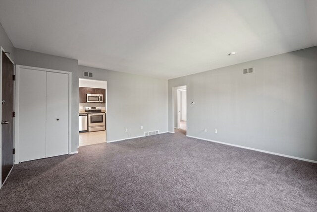 interior space with baseboards, carpet flooring, and visible vents