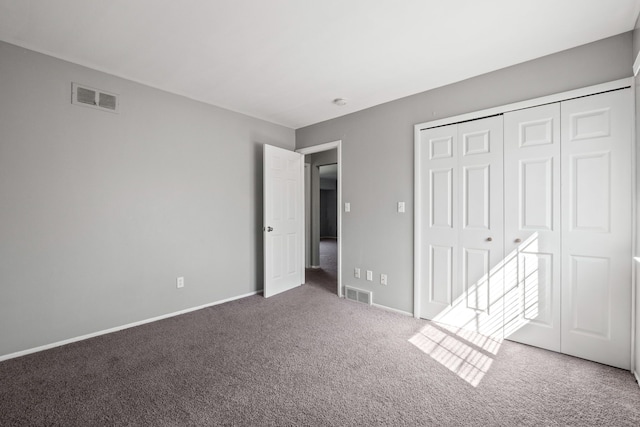 unfurnished bedroom featuring visible vents, carpet flooring, and baseboards