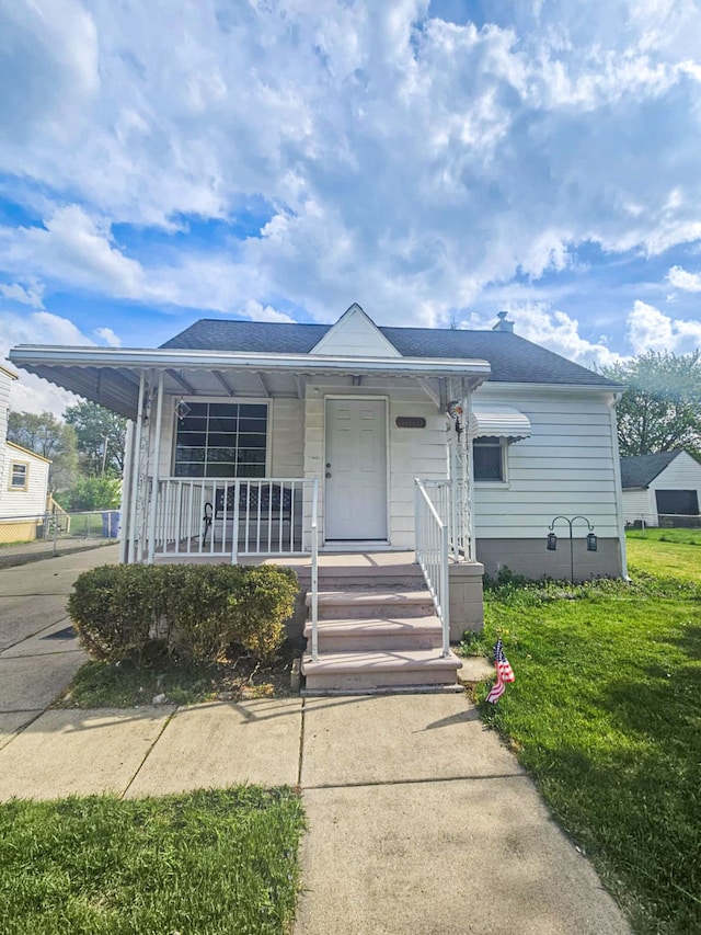 4010 Stolzenfeld Ave, Warren, MI 48091 - bungalow-style house featuring a porch, a shingled roof, and a front yard