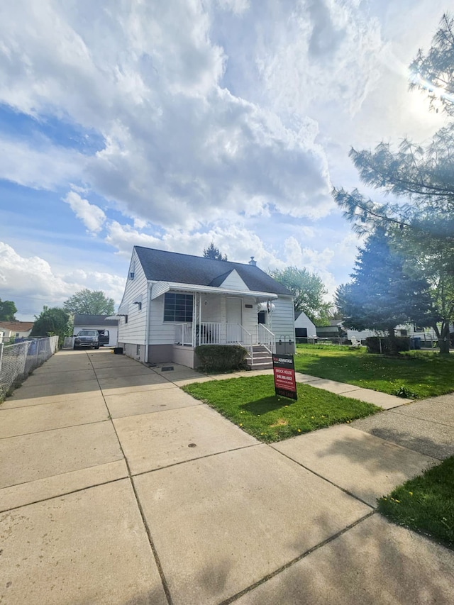 4010 Stolzenfeld Ave, Warren, MI 48091 - view of front facade featuring a porch, driveway, and a front lawn