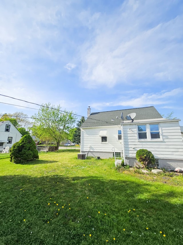 4010 Stolzenfeld Ave, Warren, MI 48091 - rear view of house with a lawn and a chimney