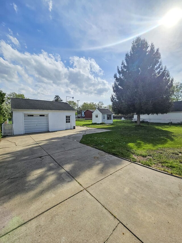 4010 Stolzenfeld Ave, Warren, MI 48091 - exterior space with a lawn, an outdoor structure, driveway, and a garage