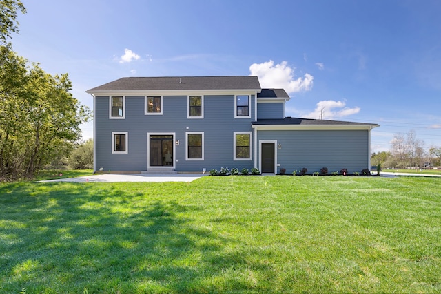rear view of house with a yard and a patio area