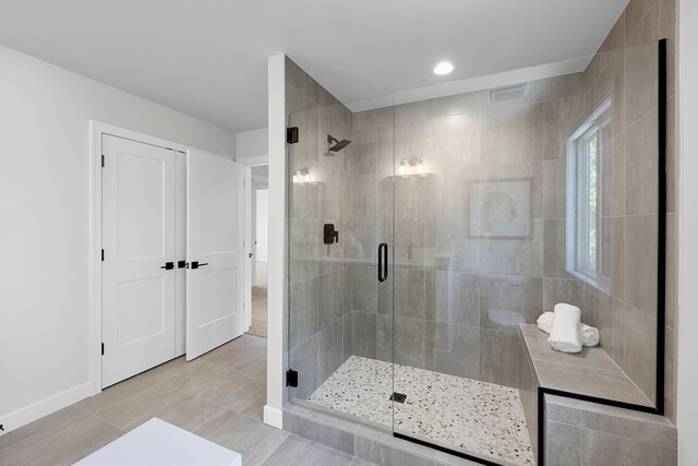 bathroom with a shower stall, tile patterned flooring, recessed lighting, and baseboards