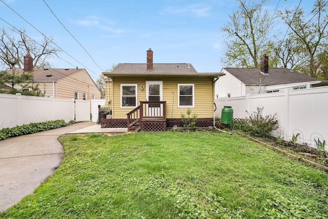 1343 Northway St, Ferndale, MI 48220 - back of property featuring a lawn, driveway, a chimney, and a fenced backyard