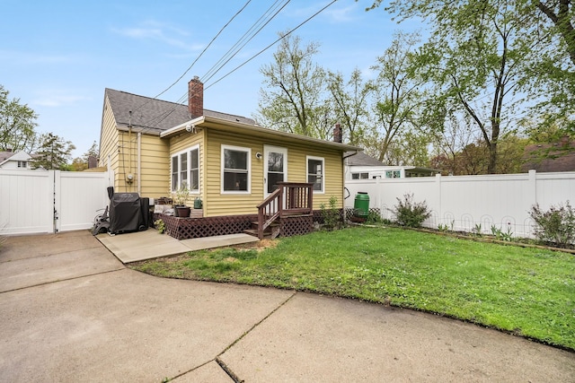 1343 Northway St, Ferndale, MI 48220 - rear view of property featuring fence, a gate, a chimney, a patio, and a yard