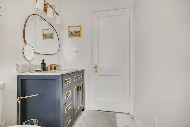 1343 Northway St, Ferndale, MI 48220 - bathroom featuring toilet, baseboards, marble finish floor, and vanity