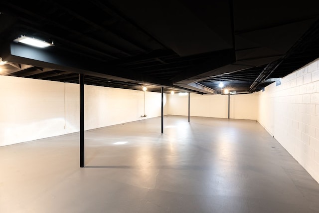 finished below grade area featuring concrete block wall