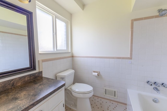 bathroom with visible vents, vanity, toilet, tile walls, and a bath