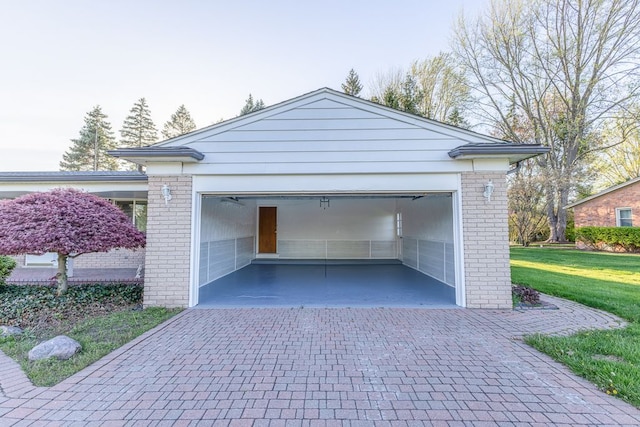 garage with decorative driveway