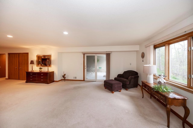 sitting room with recessed lighting, baseboards, and light colored carpet