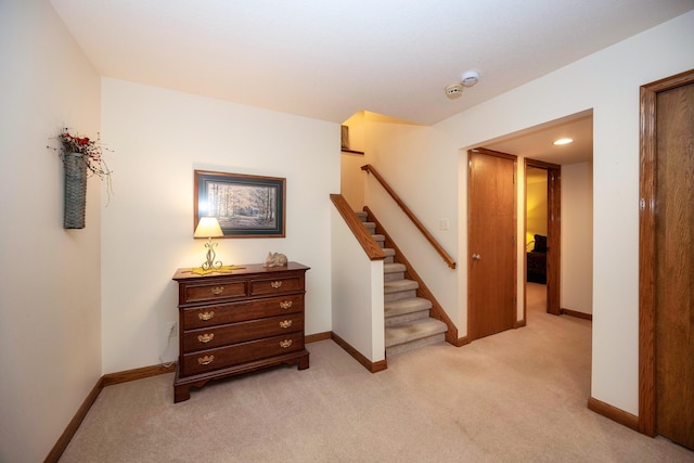 staircase featuring carpet flooring and baseboards
