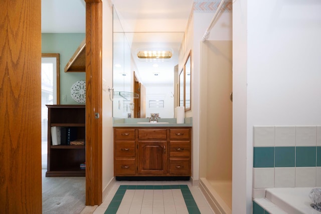 bathroom with baseboards, tile patterned flooring, a washtub, and vanity