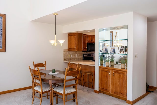 dining space with baseboards, a notable chandelier, and light carpet