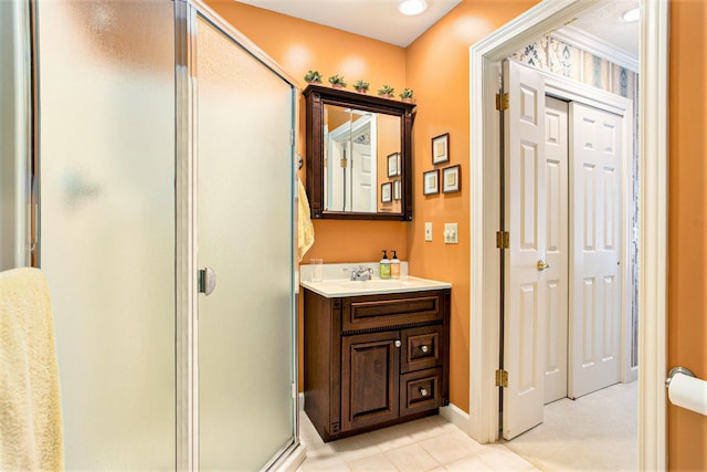 full bath with vanity, baseboards, tile patterned flooring, and a shower stall