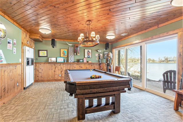 rec room with pool table, wainscoting, wood walls, wooden ceiling, and light carpet