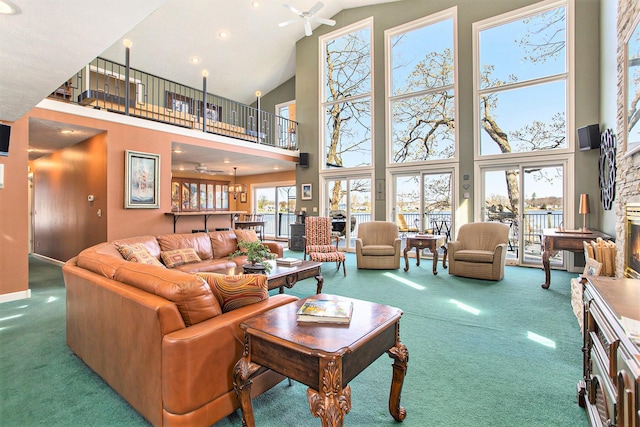 carpeted living area featuring baseboards, a ceiling fan, recessed lighting, and high vaulted ceiling